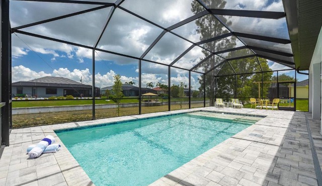 Pool overlooking canal, Outdoor Grilling station - Villa Sand Dollar Siesta in Cape Coral